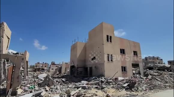 Palestinians inspect residential buildings that were destroyed during Israeli raids amid the ongoing conflict between Israel and Hamas, in Khan Yunis, southern Gaza Strip