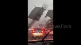 Extreme weather causes steel shed to fly off rooftop damaging cars and power lines