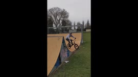 Backflip bike fail: cyclist tumbles using tree trunk ramp