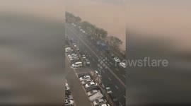 Parked cars demolished by toppling walls hit by storm-force winds