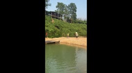 Bicycle mishap: crossing Vietnam's monkey bridge ends in a splash