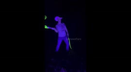 Man Practices With Glow in the Dark Whips at Night