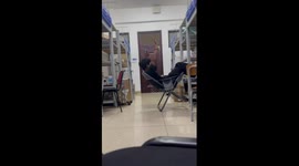 Chair topples over while boy leans backwards