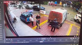 Cash transport vehicle reverses into security guard and traps him underneath in China