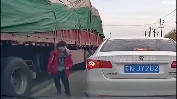 Daredevil boy risk lift to take shortcut beneath moving truck in China ...
