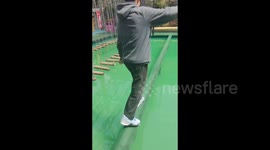 China: Falling into a Pool from a Log Bridge