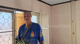 Firemen smash ceiling to remove huge python from family's home