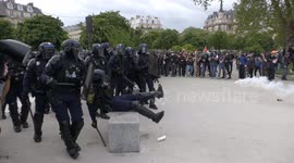 French policeman tumbles over park bench during clashes in Paris on May Day