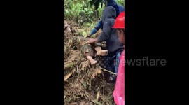 The moment residents evacuate victims who were swept away by flash floods in Luwu, South Sulawesi
