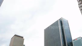 A Commercial Plane Seen Flying Over Canary Wharf Buildings Toward City Airport