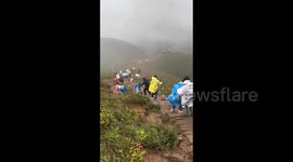Torrential rain turns mountain hike into special forces challenge for visitors in China