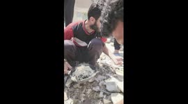 Palestinians inspect the remains of the martyrs who fell as a result of the Israeli warplanes bombing the Al-Afifi family home in Rafah.