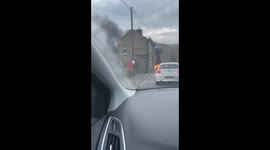Man drives past TVR FULLY ENGULFED in FLAMES outside primary school