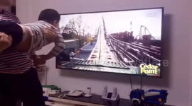 Father creates human rollercoaster for his son while watching a POV rollercoaster ride on TV