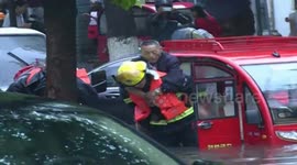 Firefighters help students get through flooded streets to get to school