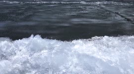 Stunning footage of churning ice needles on the shores of a lake