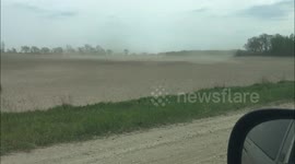 Dust cloud rolls across Minnesota field