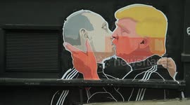 Putin and Trump share a kiss in mural graffiti - various angles mix.
