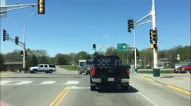 Truck peels out and shoots out black smoke in vehicle behind it.