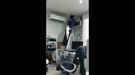 Furr-ber cables, please! Cat climbs on technician installing internet