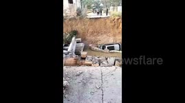 Bridge collapse leaves car plunging into water in central China