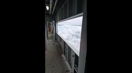 Massive waves crash into a ship, surging through its corridors