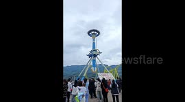 FURTHER FOOTAGE: Tourists left hanging upside down in mid-air as amusement swing ride grinds to halt in southern China