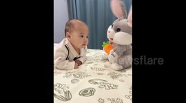 China: Child and toy rabbit
