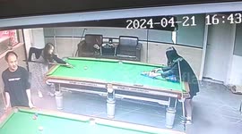 Woman chips white ball onto friend's head while trying to break