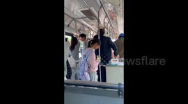China: A girl carries a duckling in her arms on a bus
