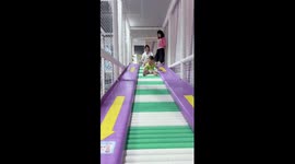 Baby's legs vibrate on tube roller slide