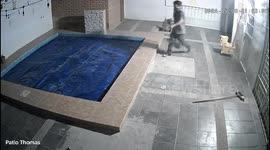 Hilarious scene as burglar foiled after falling into covered pool