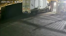 Strong winds northern China blow parked heavy truck into gate