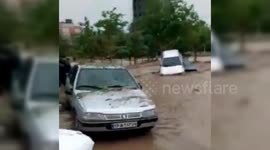 Vehicles swept along road by flooding in Iranian city of Mashhad