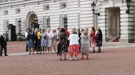 Senior Citizens enjoy a song and a dance as they depart Buckingham Palace