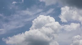 White cumulus clouds building in a time lapse video.
