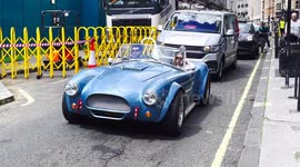 A Blue Classic Convertible Car Seen Driving Around The West End