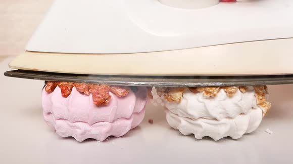 Hot iron pressed against marshmallow makes for satisfying footage