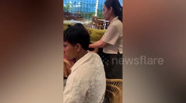 Woman shelters frightened pet dog during thunderstorm