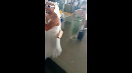 Man Walks Through Airport In Wedding Dress