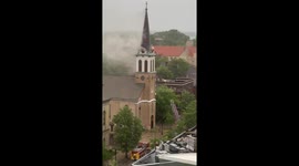 A fire breaks out on the steeple of Holy Redeemer Catholic Church in Madison, WI. A lightning strike is thought to have caused the fire.