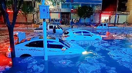 Chunks of ice formed by the hailstones float on flooded streets in China