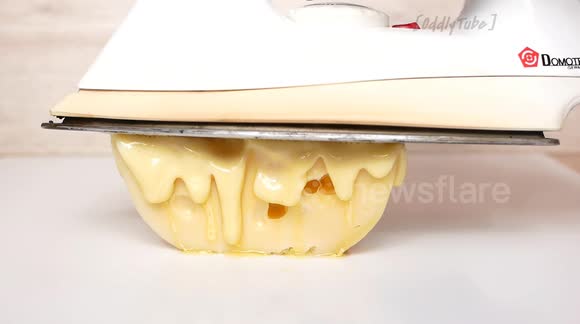 Satisfying footage shows hot iron melting cheese