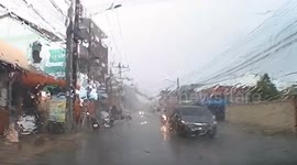 Tree falls onto road causing power lines to explode during storm
