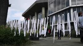 Protesters hang hundreds of white ribbons representing children killed in Gaza outside town hall in UK