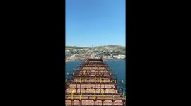 Cargo container ship on last voyage running aground on land for beaching and scrapping