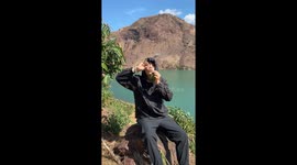 Chinese boy blows magic bubbles from tree leaves
