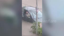 Woman rescued from car in flood by traffic police in western India