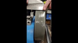 Grinding the bevel of a handmade chef's knife to a very sharp edge.