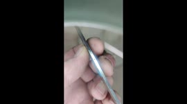 Testing the strength of a handmade kitchen knife by bending it roughly. No doubt, not strong enough.